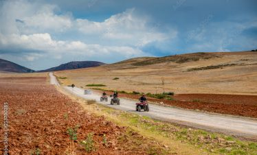 Squad of bikers are riding through valley in Peru