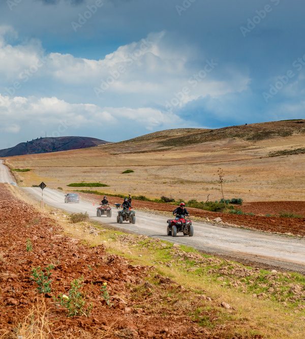 Squad of bikers are riding through valley in Peru